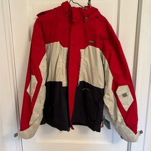 Small red white and blue ski jacket with gators and pockets. Unisex